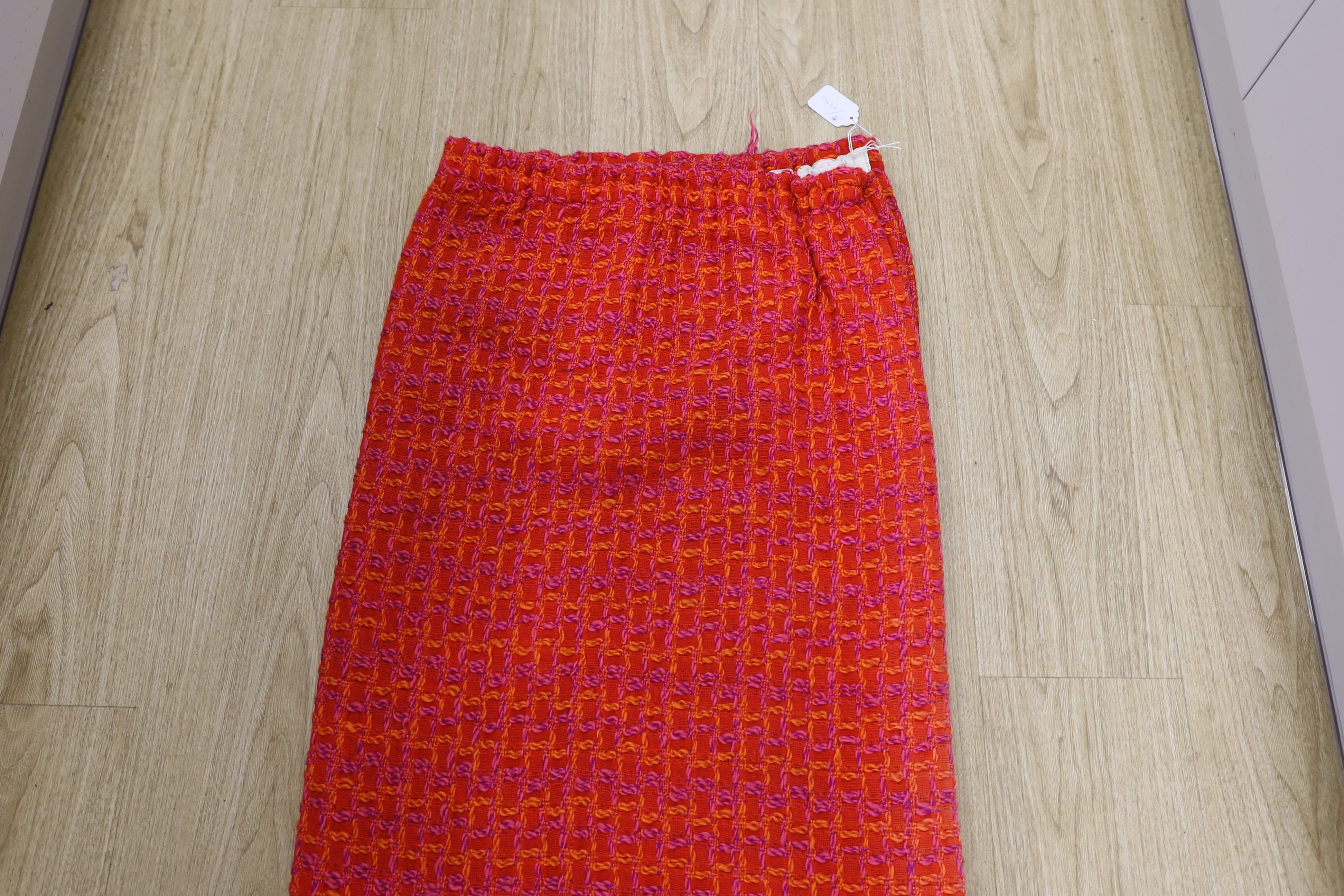 An unusual woven 1960's curtain in orange, pink and purple wools in a square overall pattern